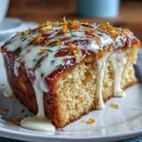 Cool Heavenly Blood Orange Yogurt Cake on a rack with vibrant icing drizzle, ready to slice.