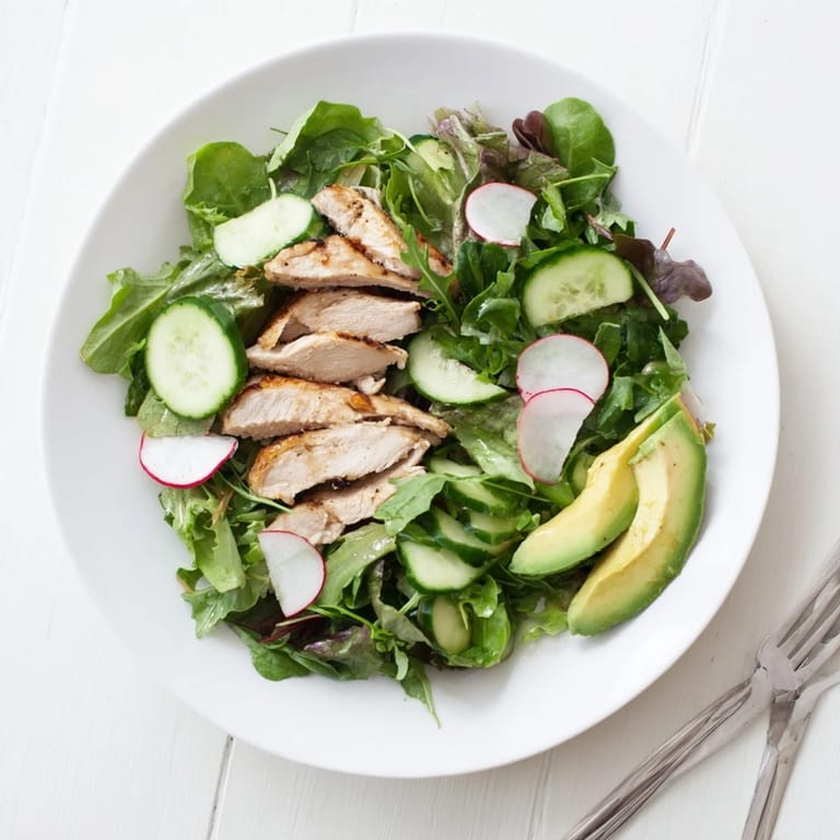 Nourishing Spring Detox Chicken Salad served on a white plate, highlighting sliced grilled chicken, mixed greens, and radish for a refreshing gluten-free main dish.